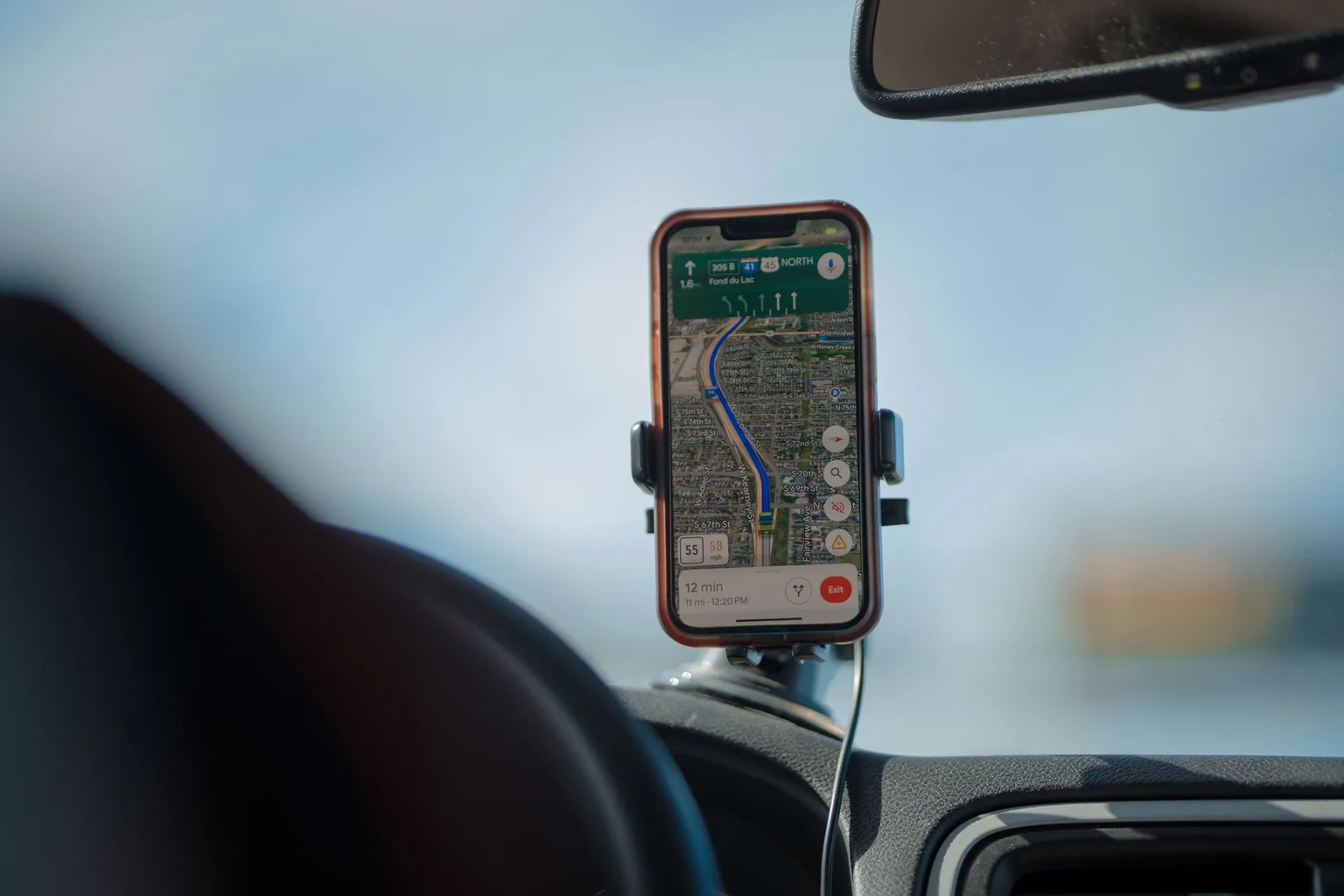 A phone showing navigation in a car dashboard mount.